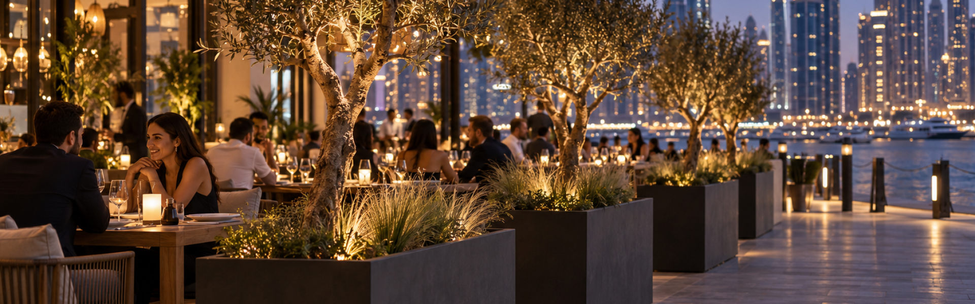 Restaurant terrace planters lining an outdoor dining area in Dubai on a winter evening
